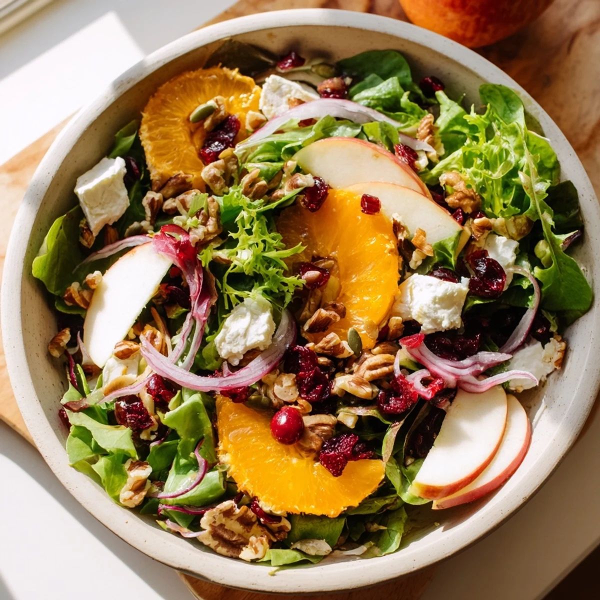 Festive Seasonal Cranberry and Walnut Celebration Salad with bright cranberries, goat cheese, and a zesty vinaigrette.