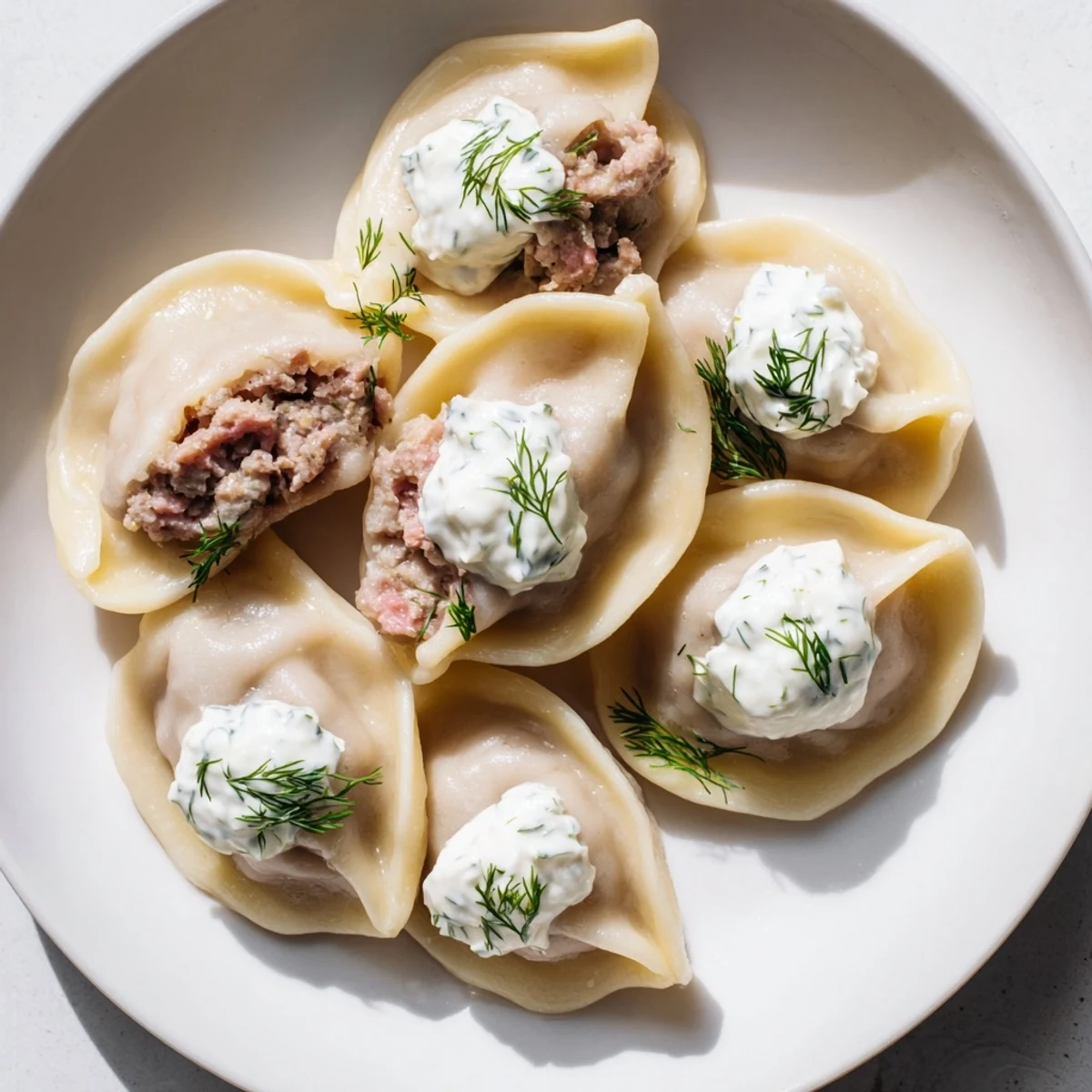 A close-up of tender Russian Pelmeni, packed with seasoned meat, showing a delicious, hearty meal.