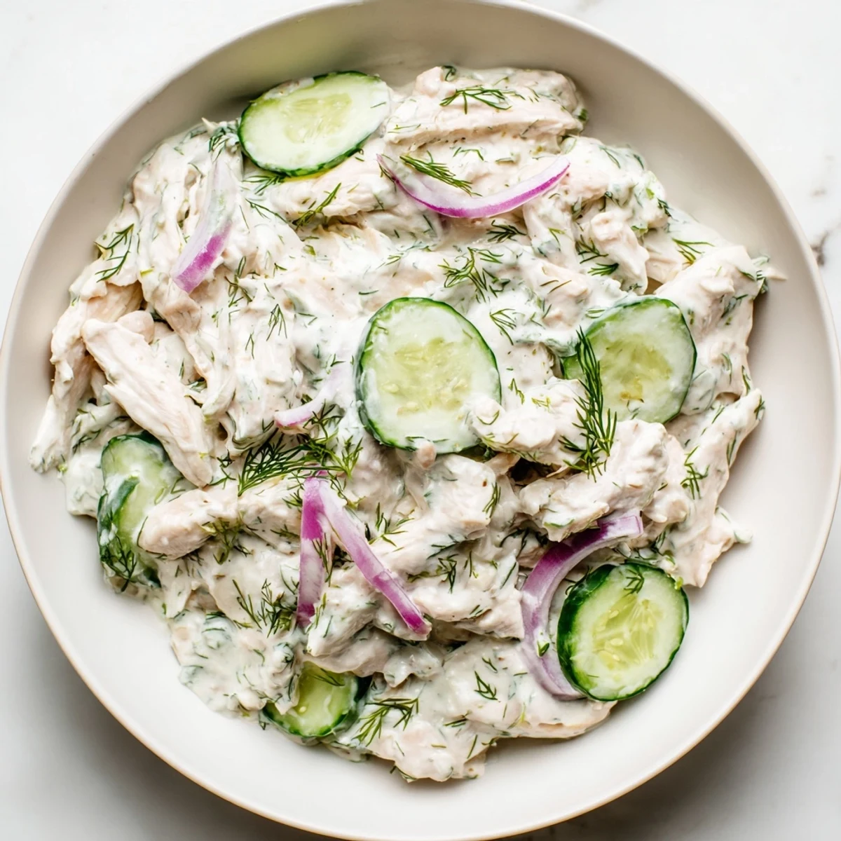 This protein-packed creamy cucumber chicken salad showcases diced chicken and sliced cucumbers in a tangy dill yogurt dressing, perfect for easy weeknight dinners.