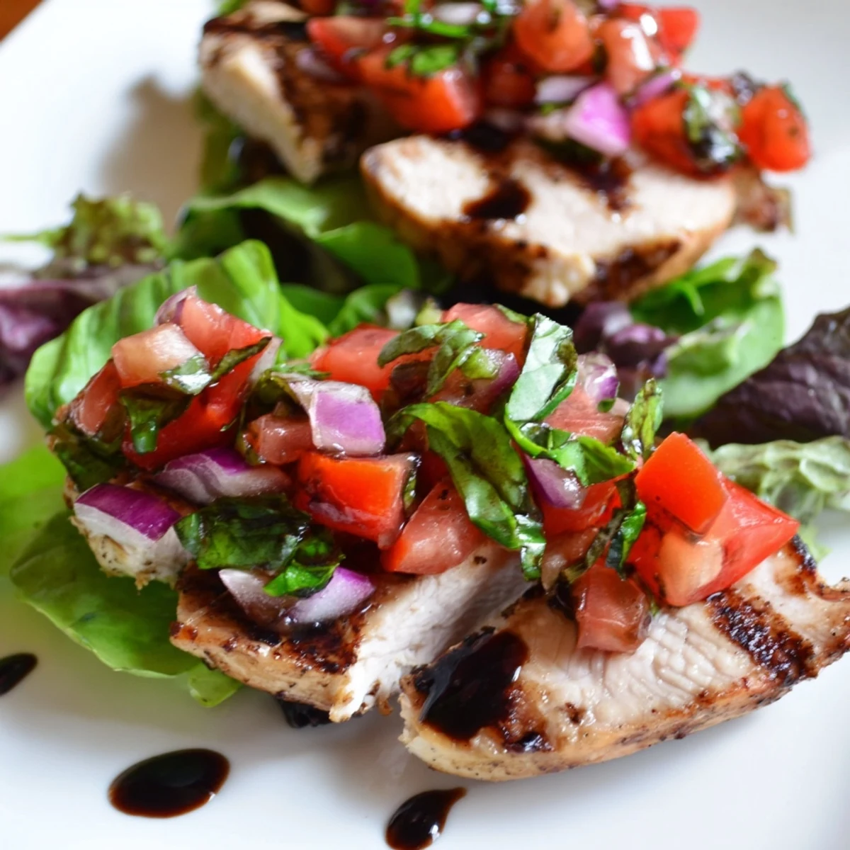 Freshly diced tomatoes and basil heap over grilled chicken in this vibrant Bruschetta Chicken Salad, perfect for summer.