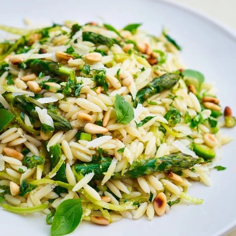 Shaved asparagus ribbons and tender orzo glisten in a lemon-olive oil dressing with Parmesan and pine nuts.