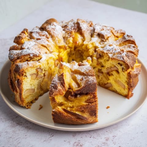 A close-up of a freshly baked Homemade Apple Turnover showing a perfect golden crust and filling.