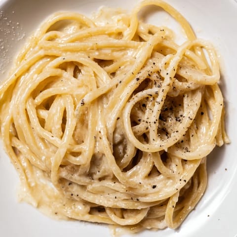 A close-up of perfectly cooked Lazy Girl Three-Ingredient Pasta, glistening and ready for that first bite.