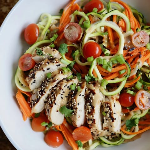 Freshly grilled chicken slices atop a colorful Protein Cucumber Salad, ready to enjoy.