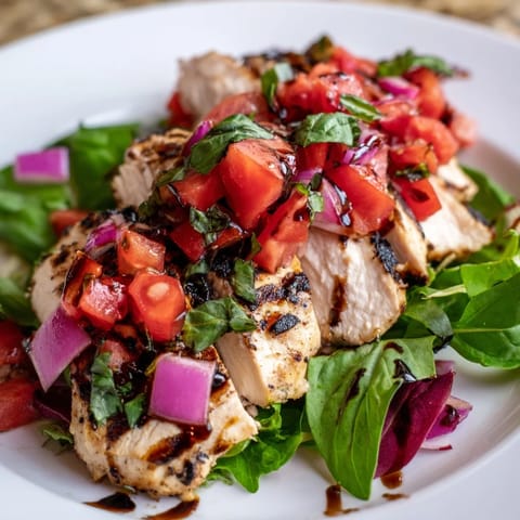 Bruschetta Chicken Salad offers a light Italian-American meal, served with lemon wedges on a rustic platter.