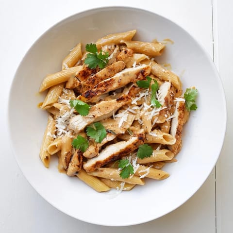 Golden seared chicken and penne pasta smothered in a creamy, sweet–smoky honey chipotle sauce garnished with fresh cilantro.
