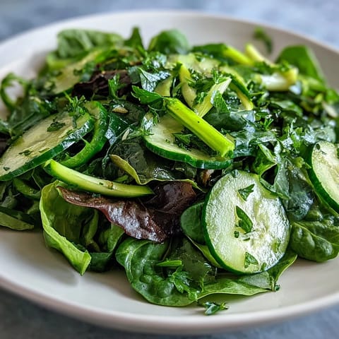 A vibrant Glowing Green Salad with crisp greens, crunchy celery, and zesty lemon vinaigrette ready to serve.  