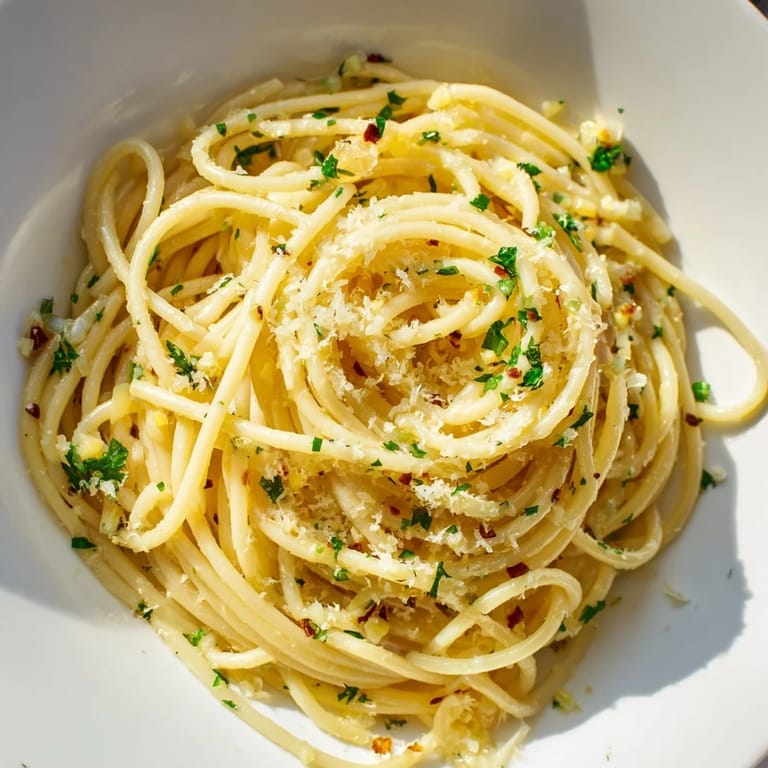 Close-up of savory Garlic Butter Noodles, a vegetarian dish with parmesan and lemon zest.