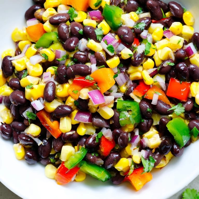 Close-up of a colorful Cowboy Caviar Salad with fresh vegetables and zesty dressing, perfect for dipping.