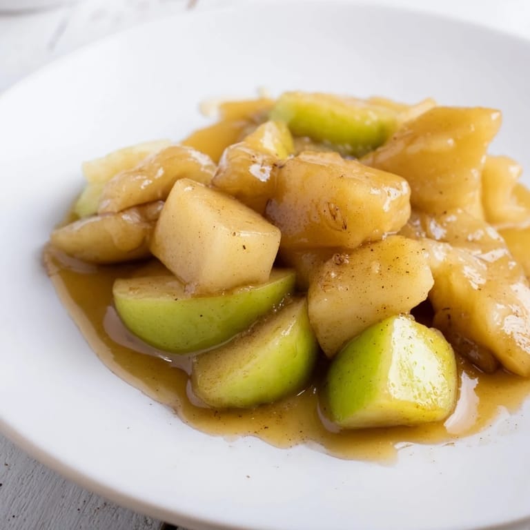Vibrant photo of easy slow cooker stewed apples; sweetened with honey and ready to serve warm.
