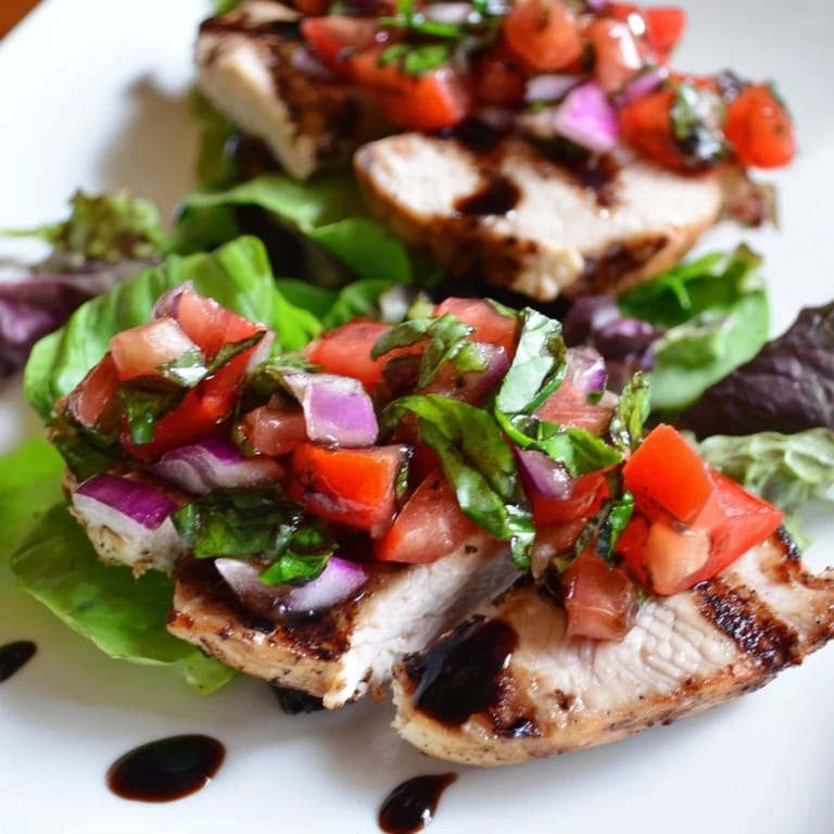 Freshly diced tomatoes and basil heap over grilled chicken in this vibrant Bruschetta Chicken Salad, perfect for summer.
